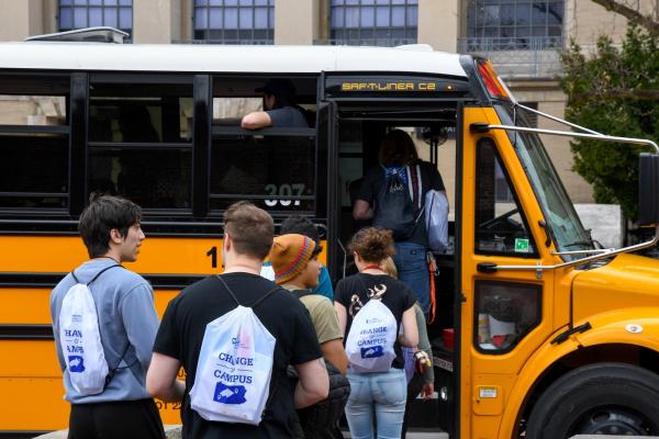 Students wait to board a bus during Link UP 2023
